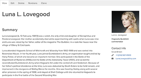 woman stands in profile position smiling into camera 