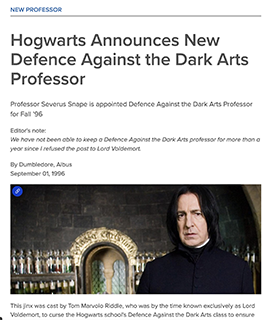 A man stands wearing a black top while standing in front of a wall of bottled spirits. 